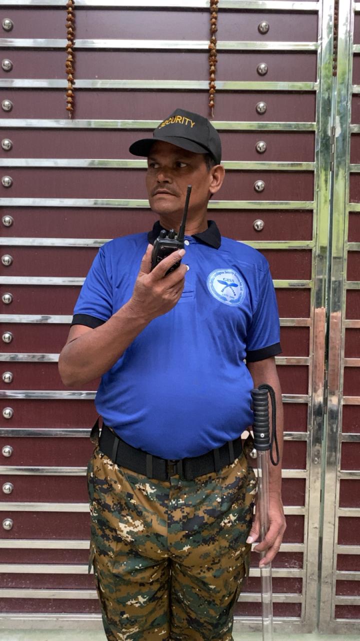 Gorkha Security Services officer standing alert at corporate entrance